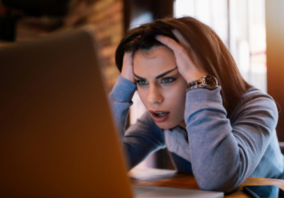 person looking concerned at a laptop