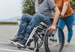 Person assisting someone in a wheelchair