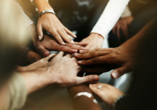 People's hands in a circle