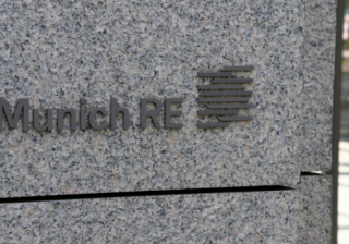 side of granite building with munich re logo carved in