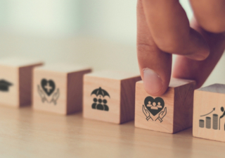 wooden blocks on a table depicting medical help scenarios