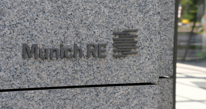 side of granite building with munich re logo carved in